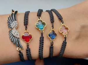5 handmade bracelets with colored stones on one wrist