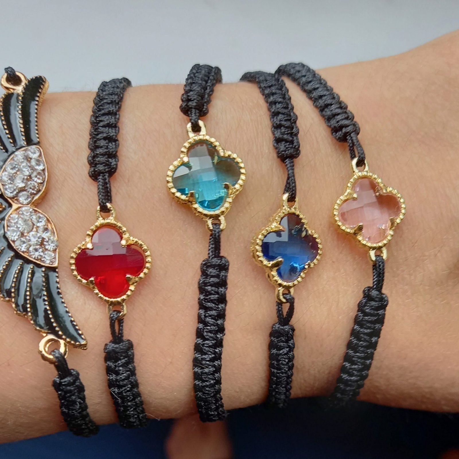 5 handmade bracelets with colored stones on one wrist